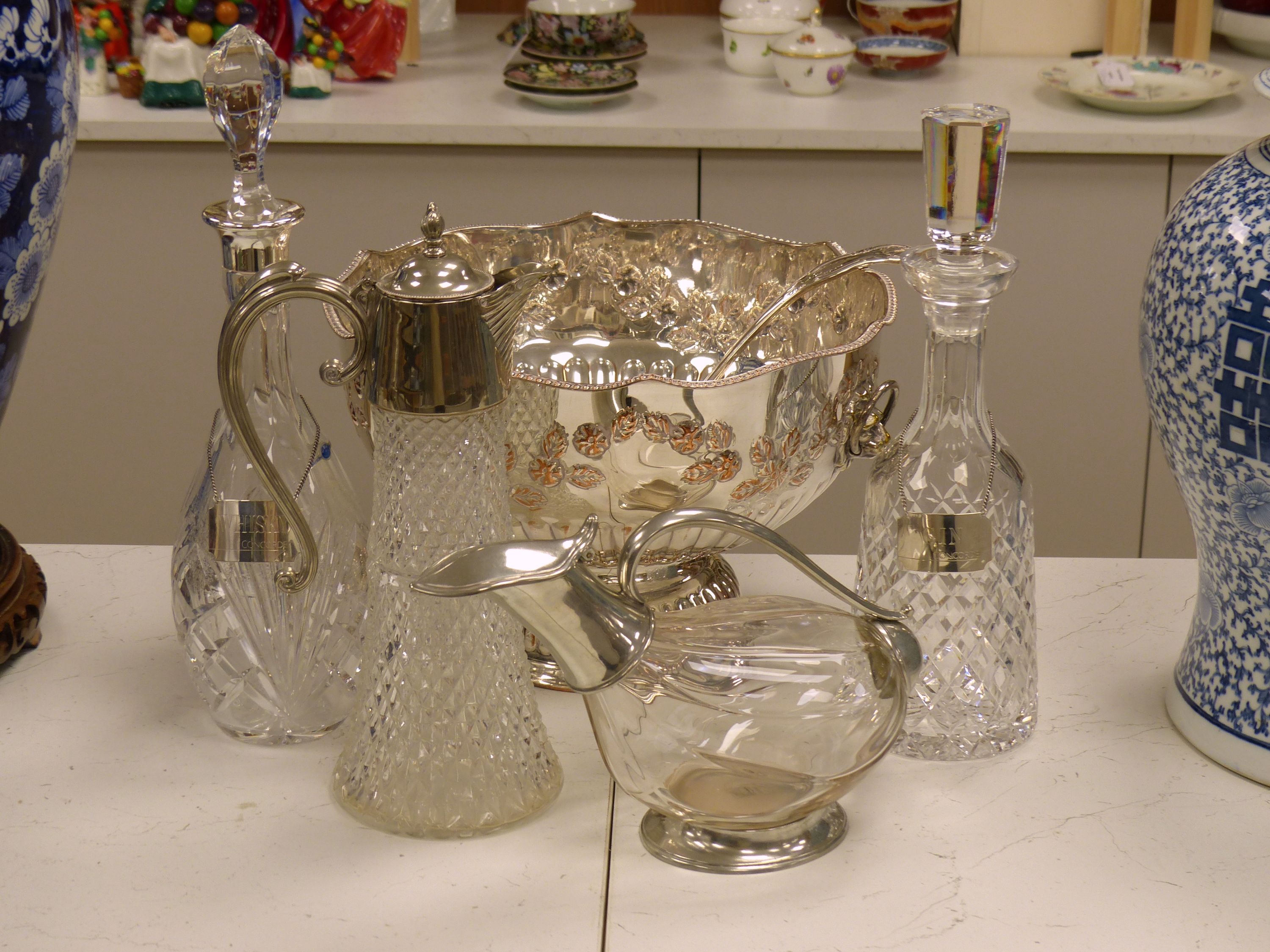 Two cut glass decanters (one silver-mounted), two silver Whisky and Gin labels, an 'Etains du Manoir' duck shaped wine carafe and two other items
